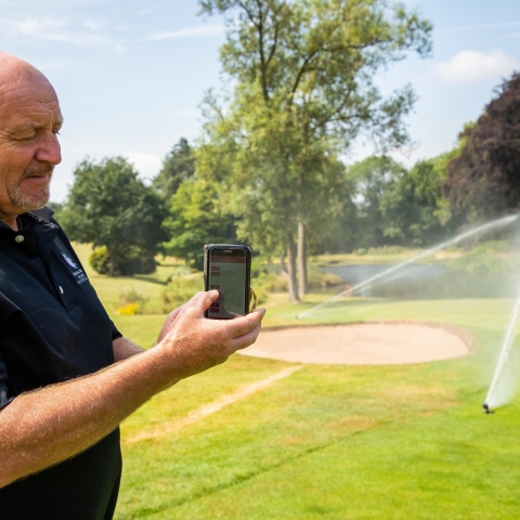 Course manager John Smith operating Toro’s Lynx central control system from his phone.
