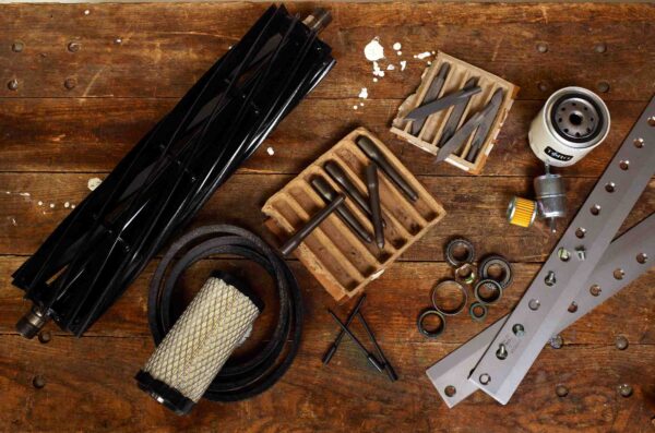 A selection of Toro parts on a work bench.