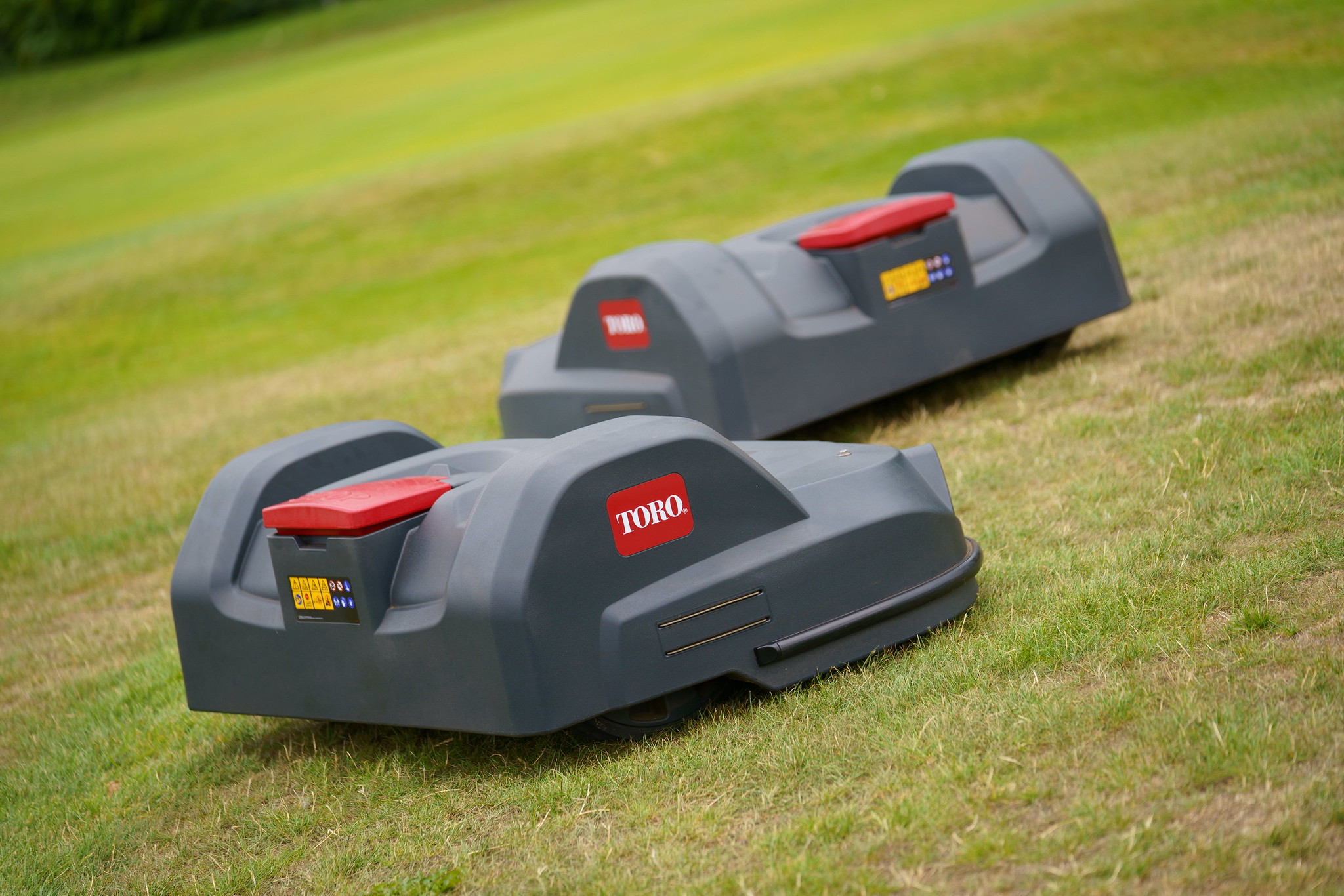 Two Toro Turf Pro autonomous robotic mowers on the greens