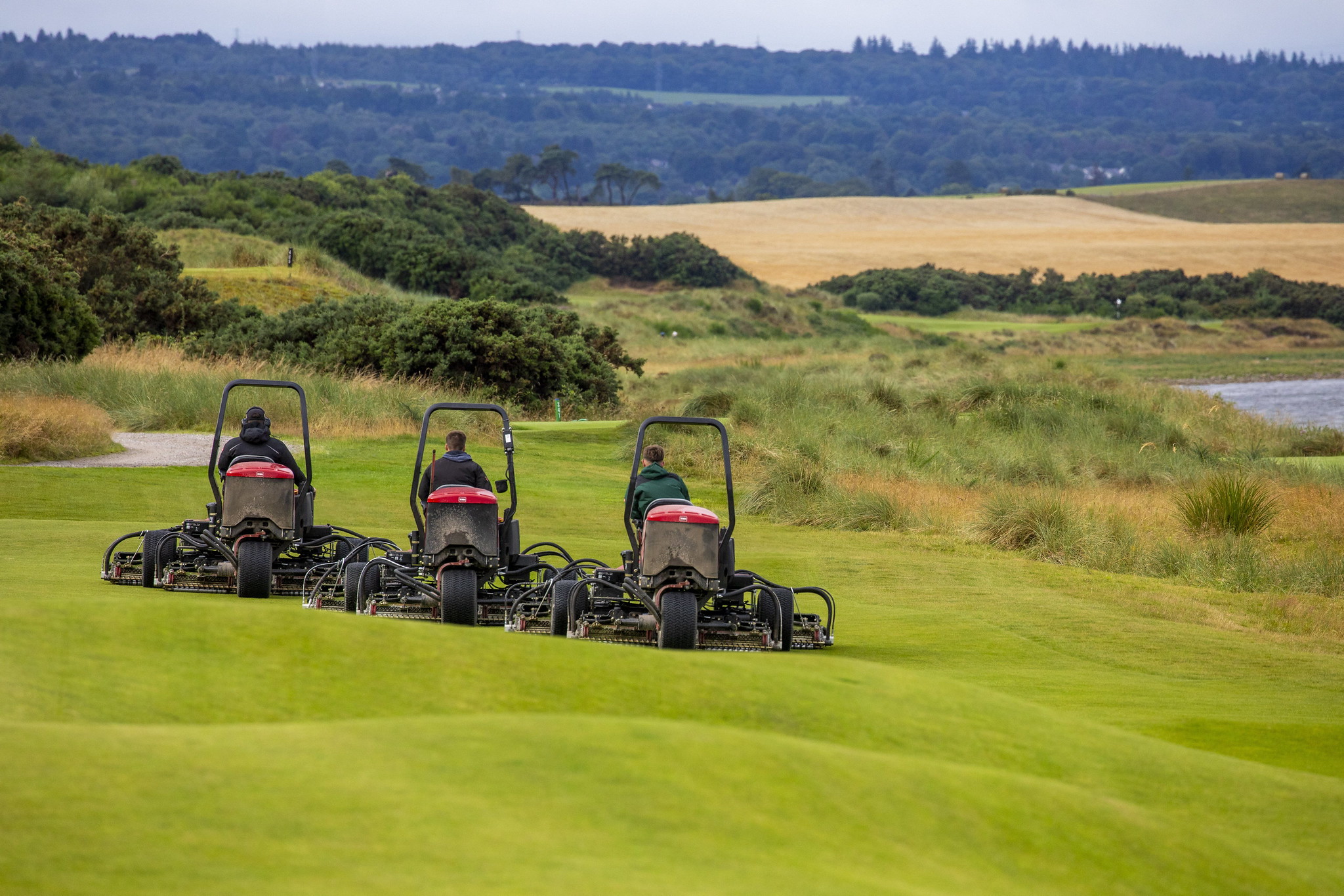 Three Toro mowers mowing the greens