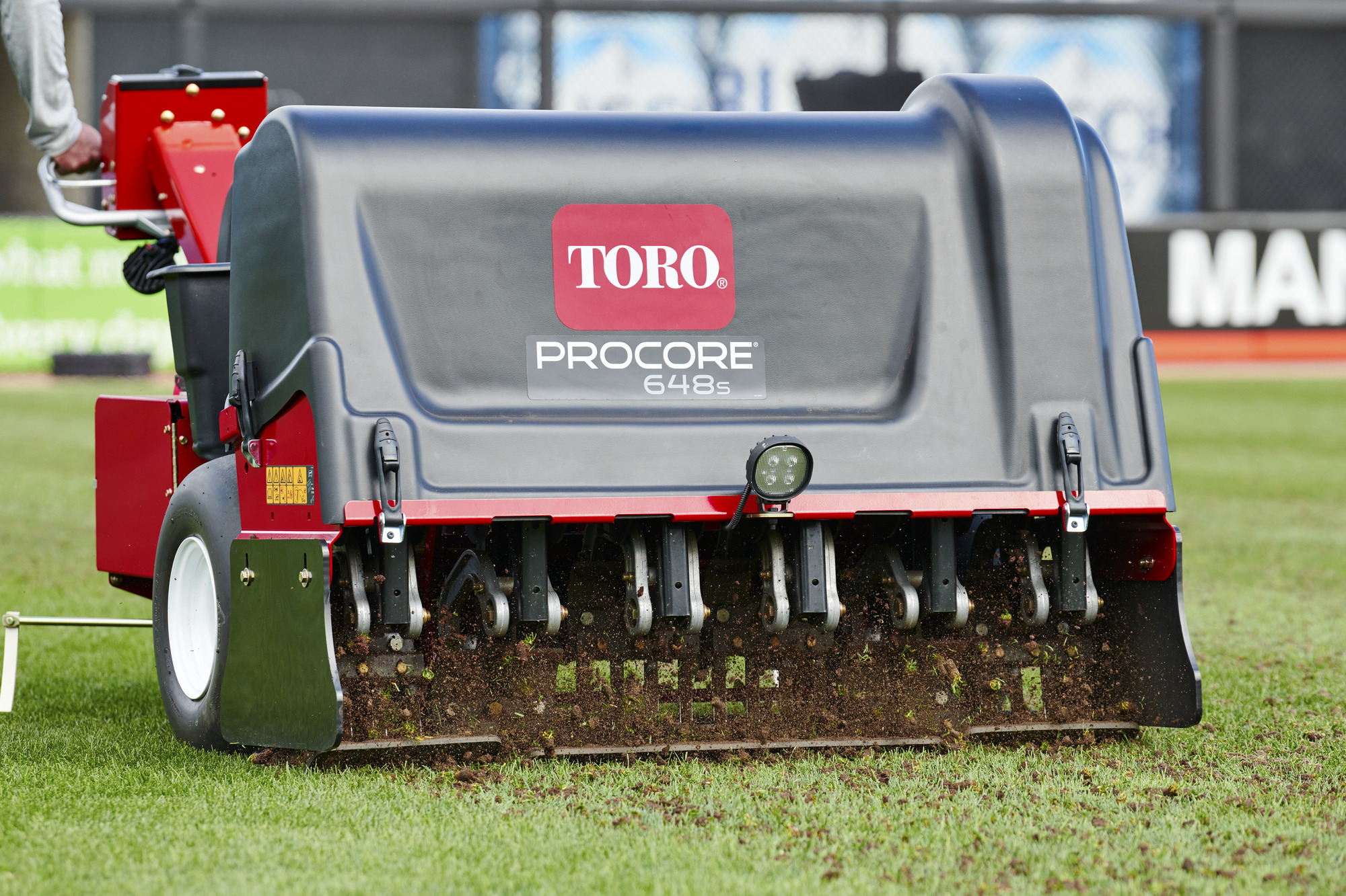 Toro ProCore 648s aerator in action on sports turf, delivering precise core removal for improved soil aeration and surface health.