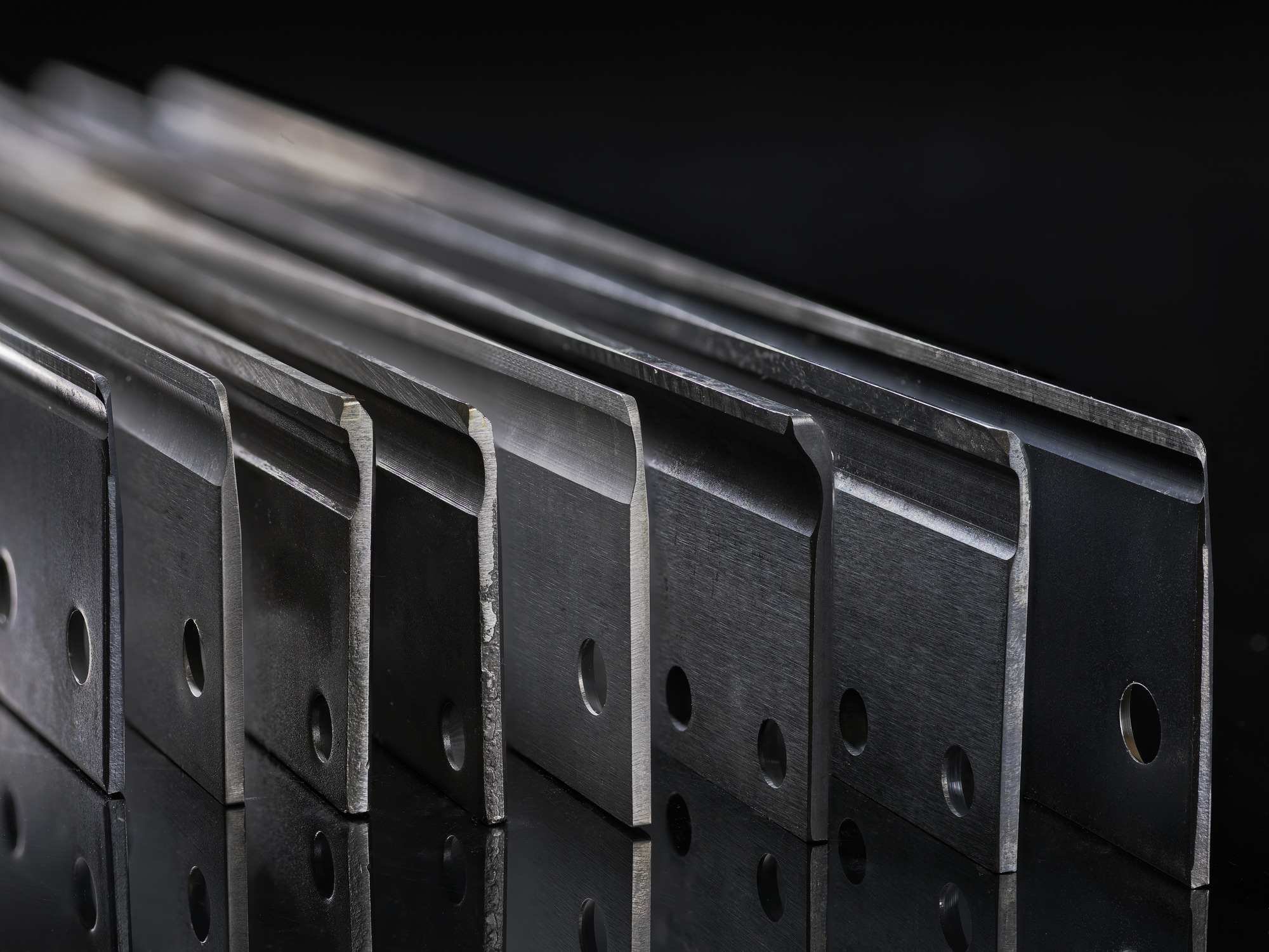 Close-up of Toro mower bedknives showing precision-ground cutting edges for professional turfcare equipment.