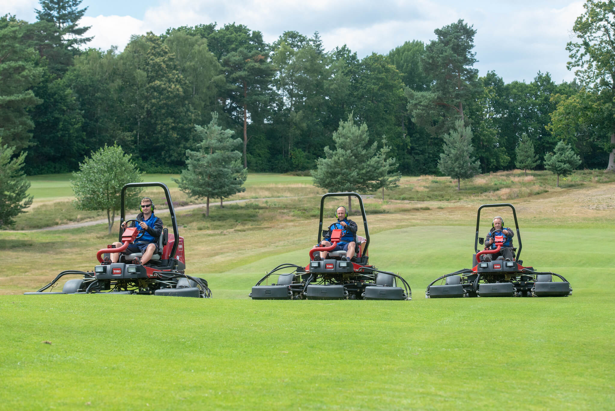 Three Toro mowers on the greens at St George’s Hill