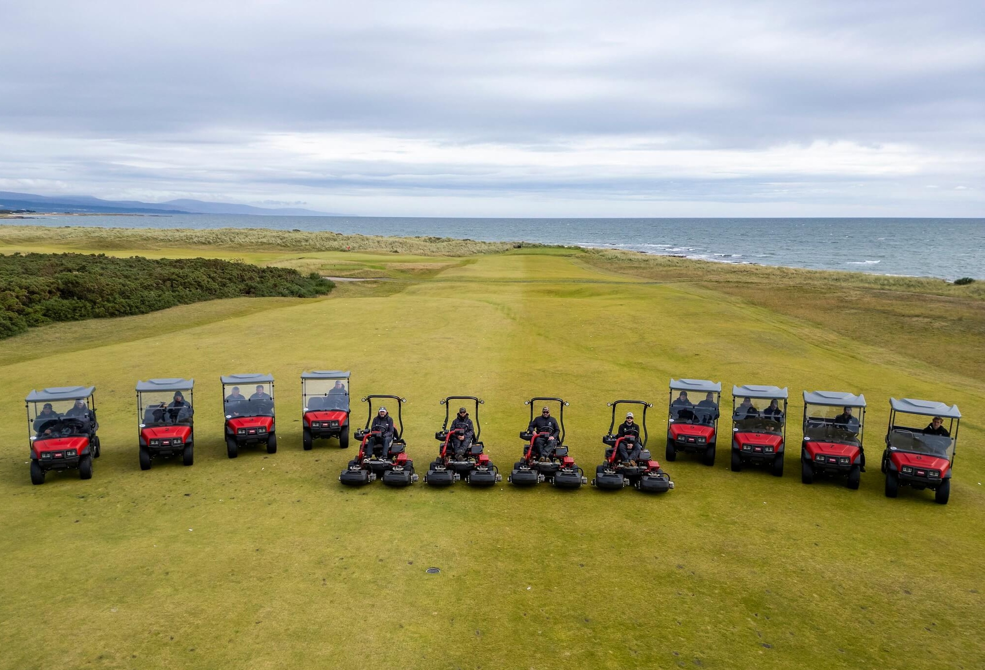 Royal Dornoch gold club's fleet of mowers and utility vehicles lined up on the fairway