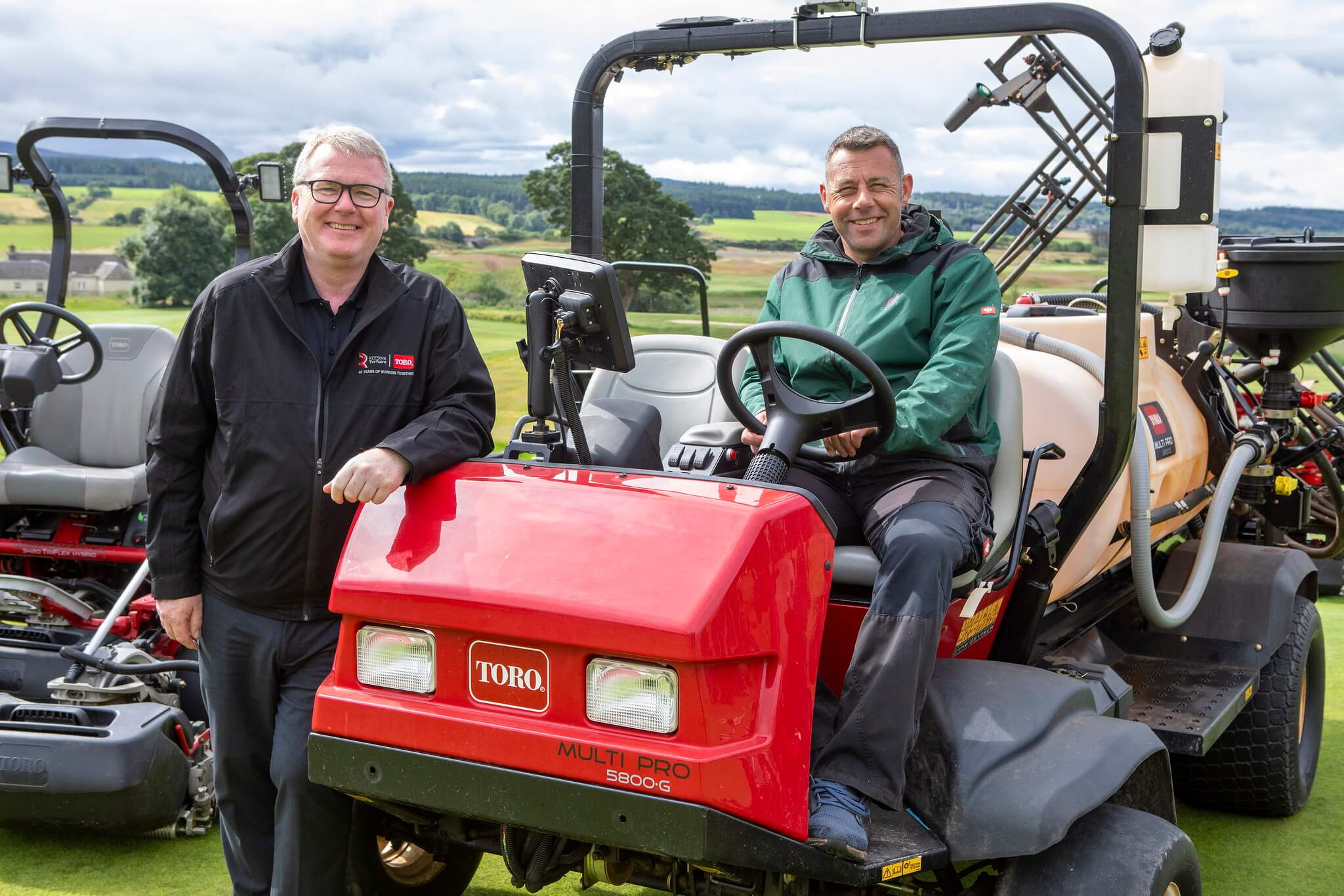 Mike Turnbull, Reesink Scotland Branch Manager, with James Hutchison beside and seated on a Toro Multi pro sprayer on Cabot Highland golf course