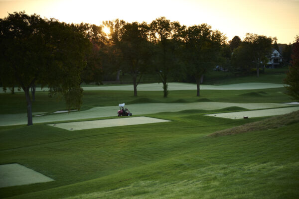 Toro autonomous fairway mower self-mows a golf course as the sun rises.