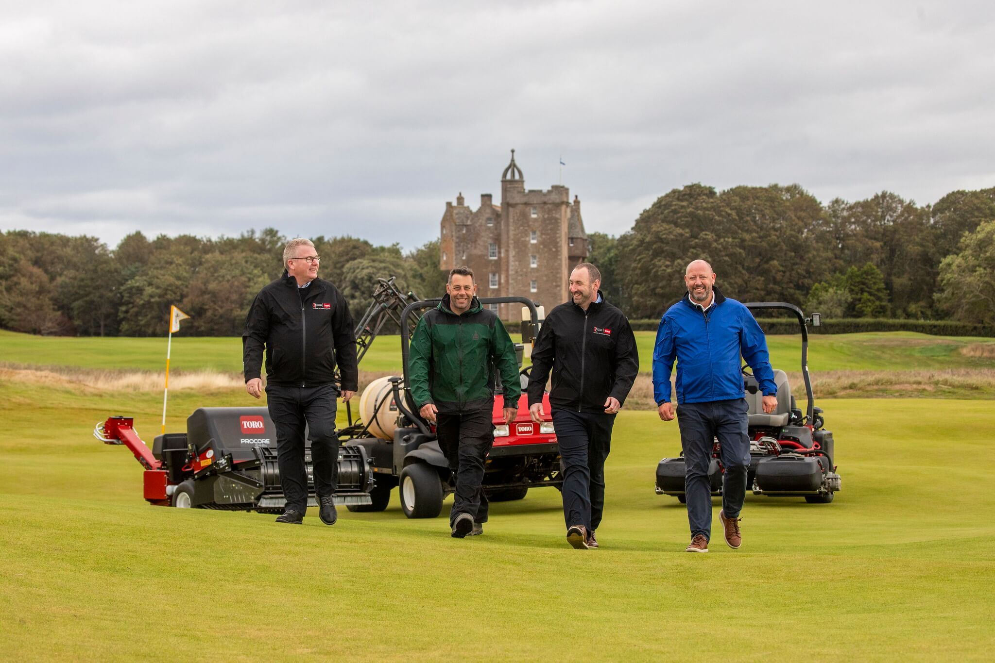 Reesink reps and greenkeepers at Calcot Park walk across the course with Toro machinery in the background.