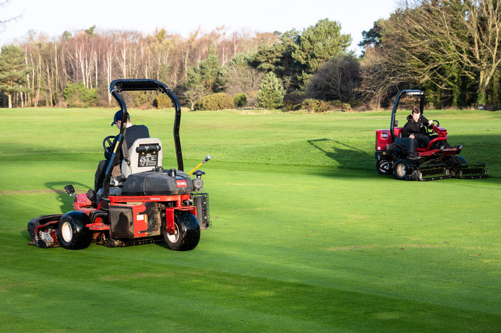 Two Toro mowers mowing the course at Massereene Golf Club.