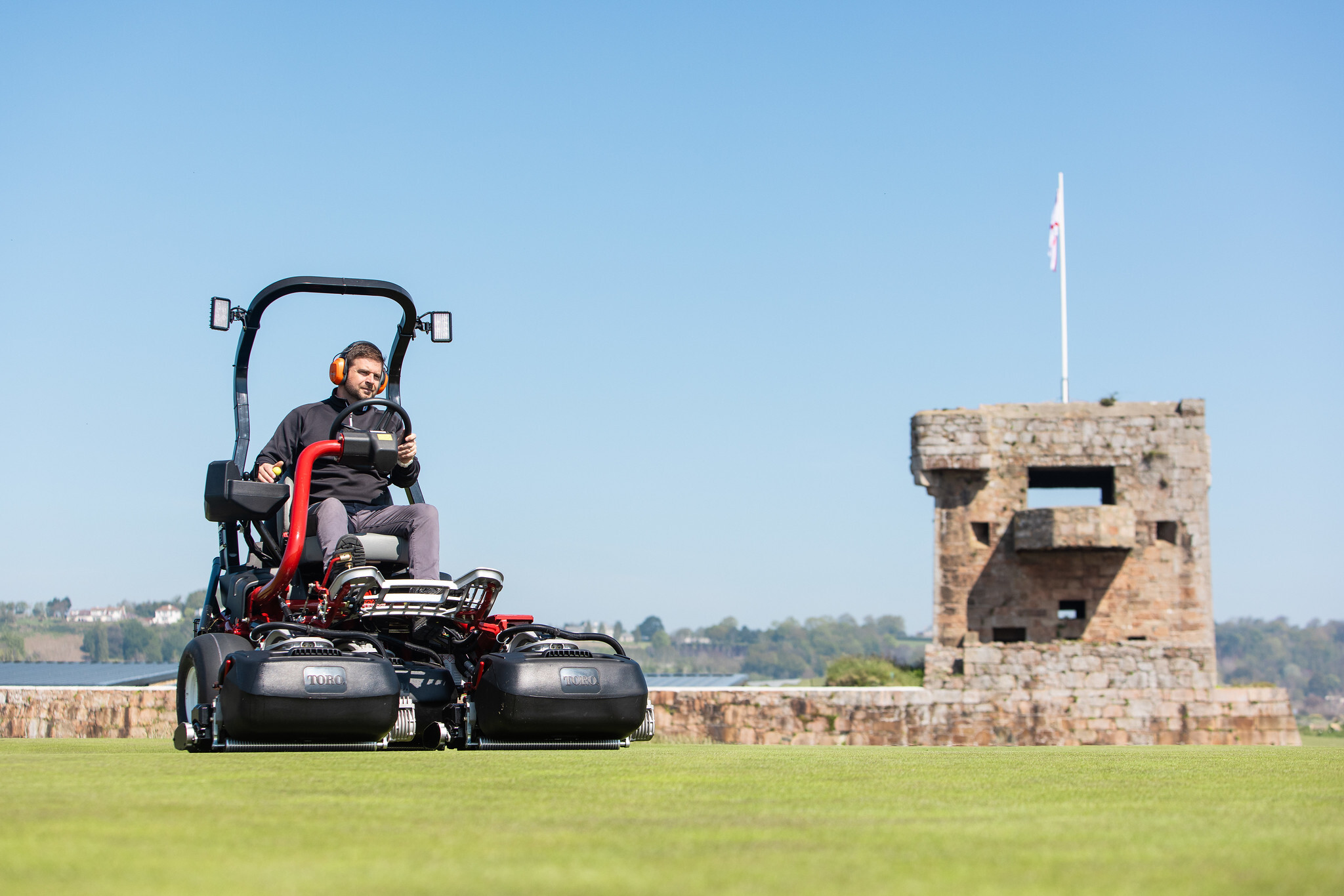 A Toro mower cutting the course at Royal Jersey Golf Club.
