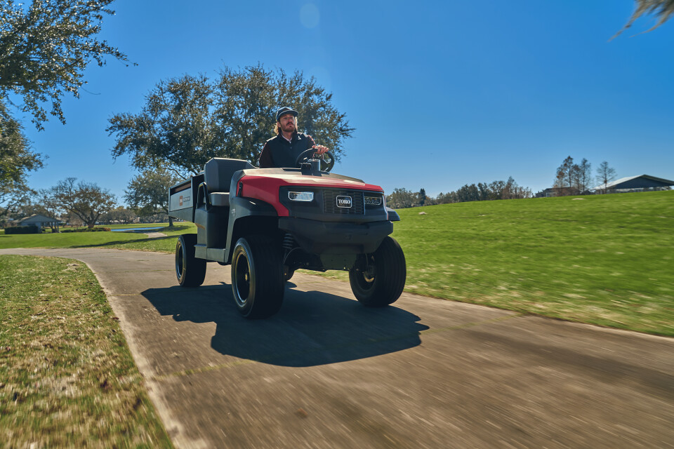 Toro Workman LTX being driven along a path.