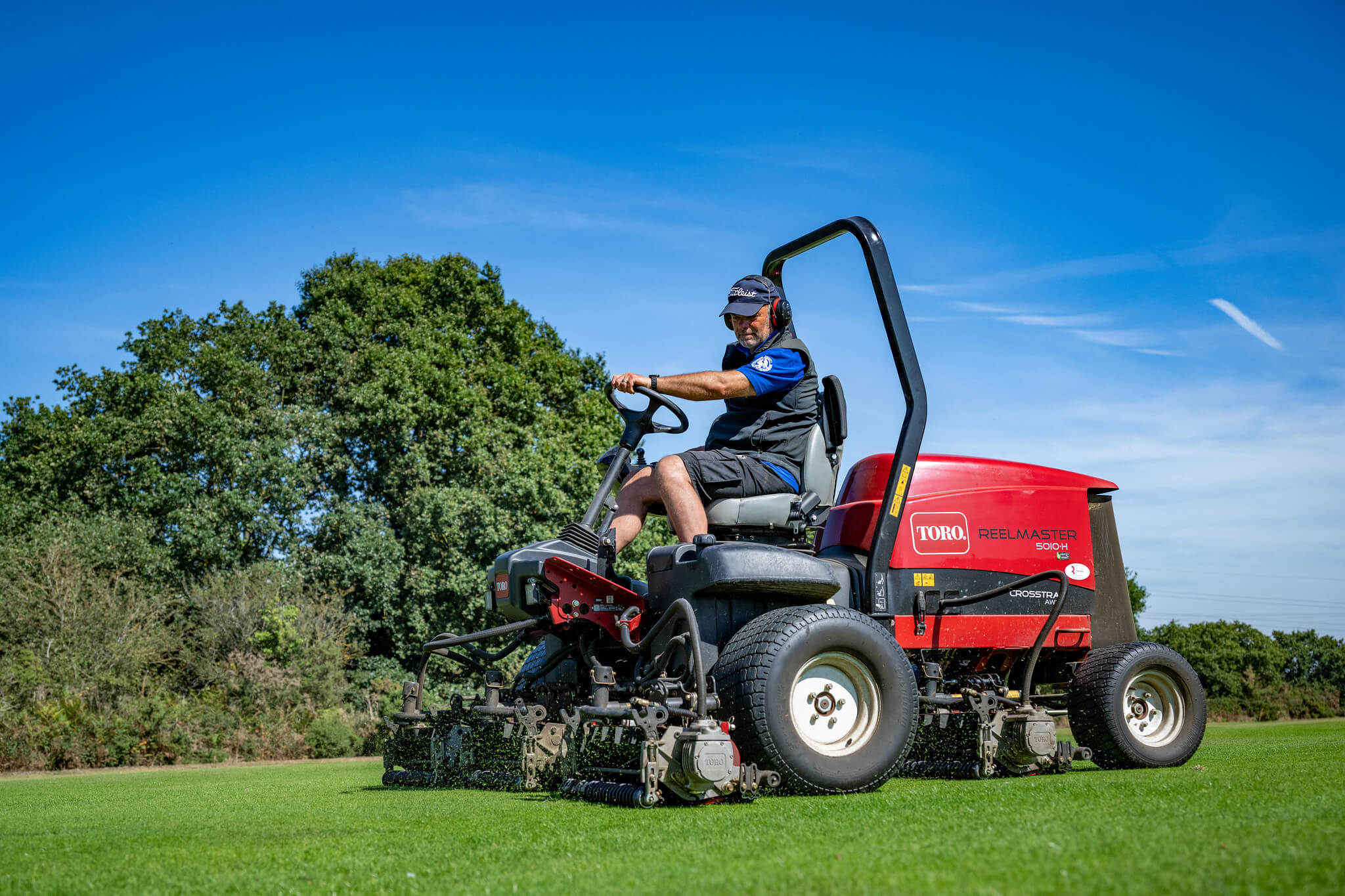 A Toro cylinder mower cutting.