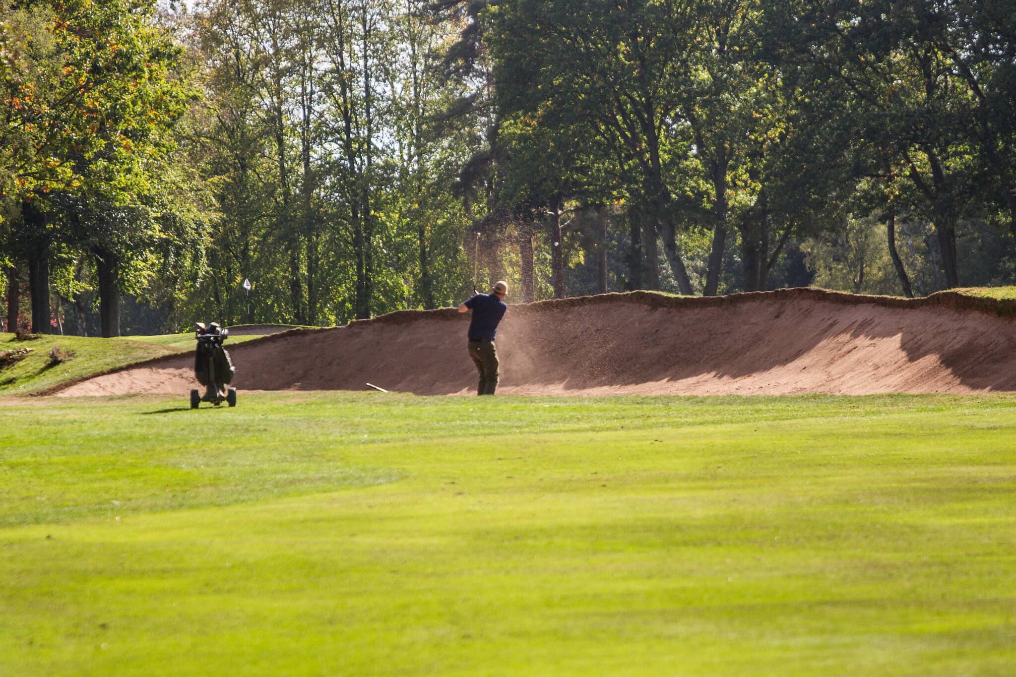 A golf club member playing on the course.