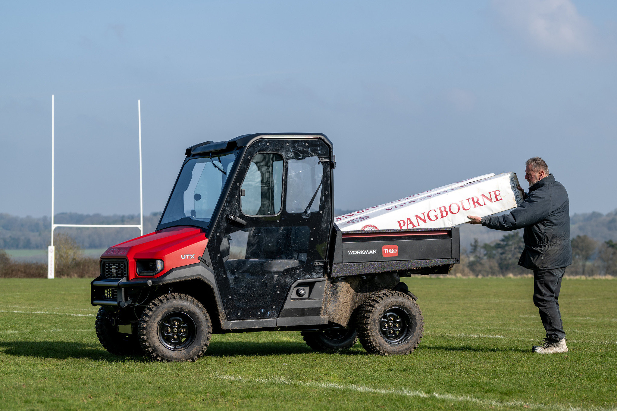 A Toro Workman utility vehicle on a sports pitch.