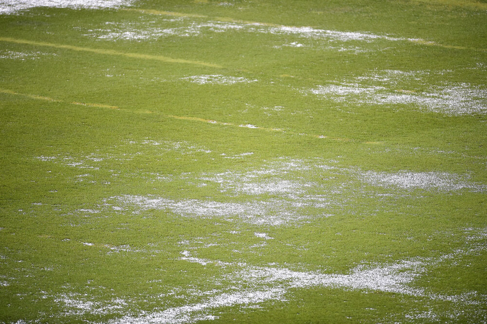 A waterlogged football pitch with water standing on it.