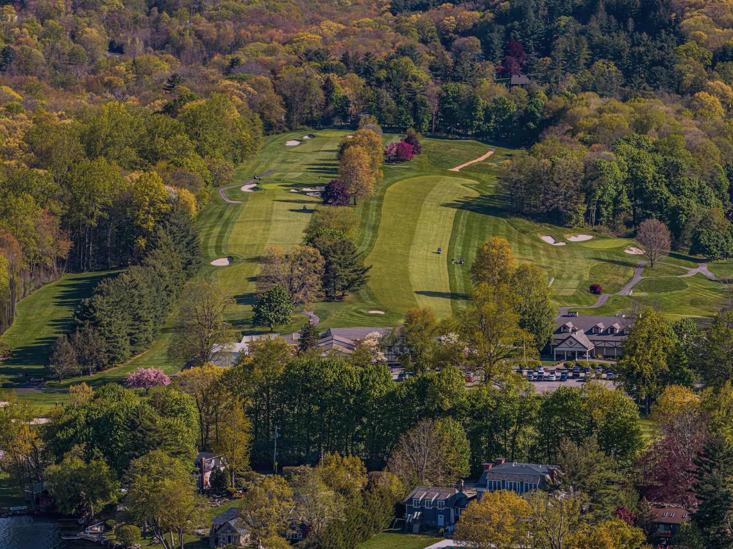 An aerial view of a golf course with a half and half fairway cut.