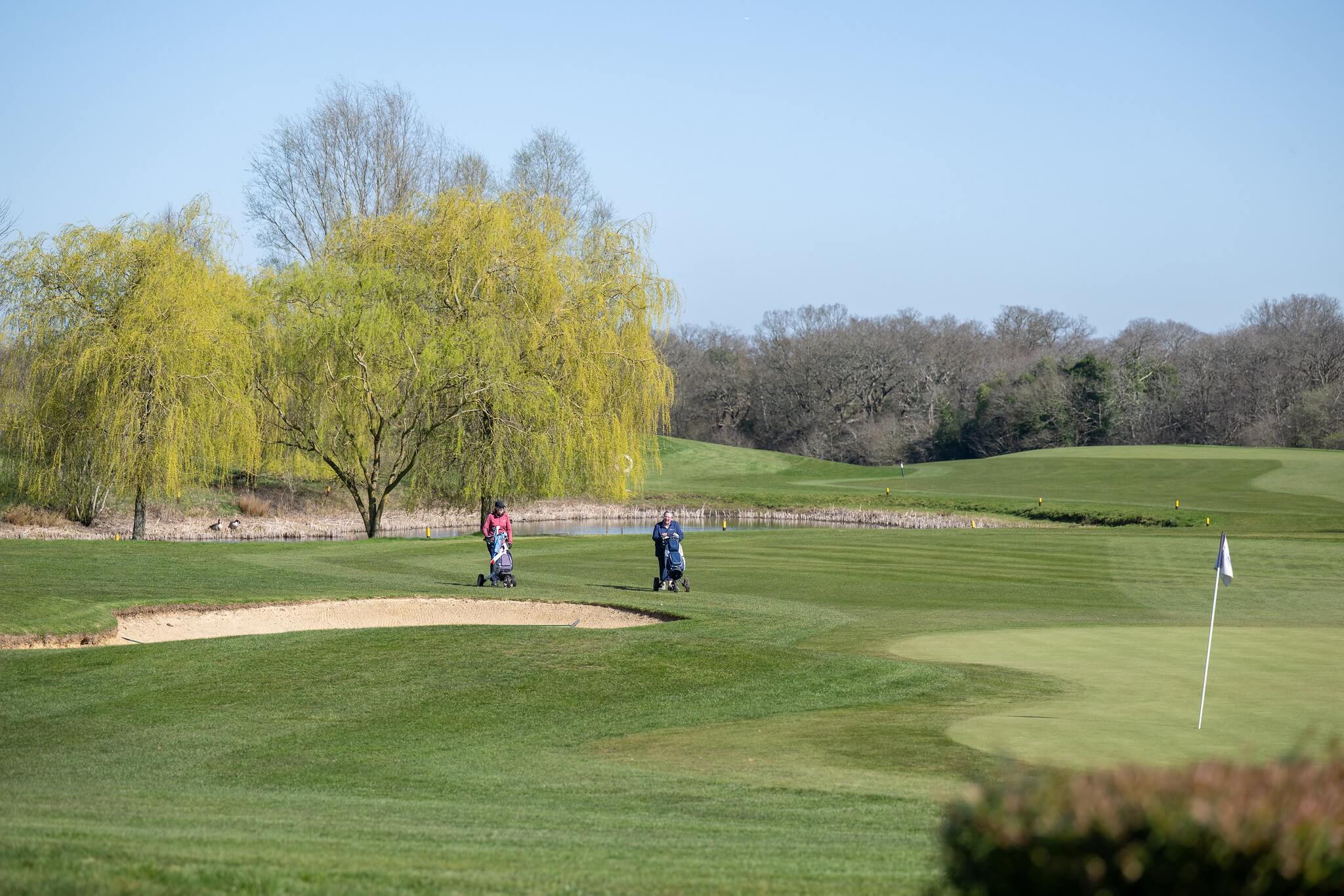 Golfers playing on a golf course.