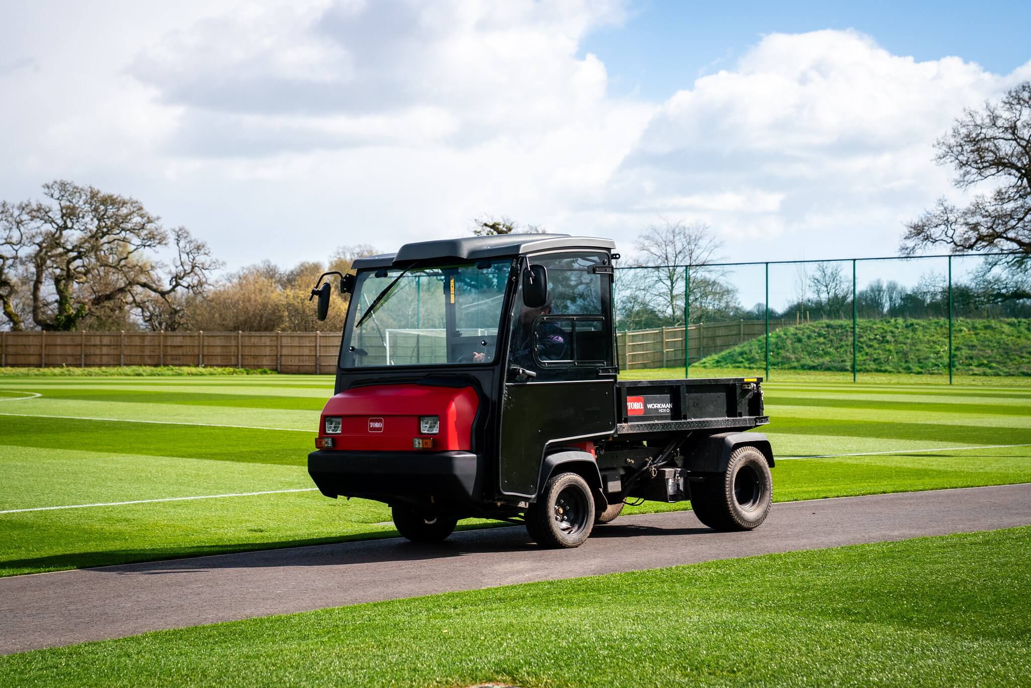 A Toro Workman next to a football pitch.