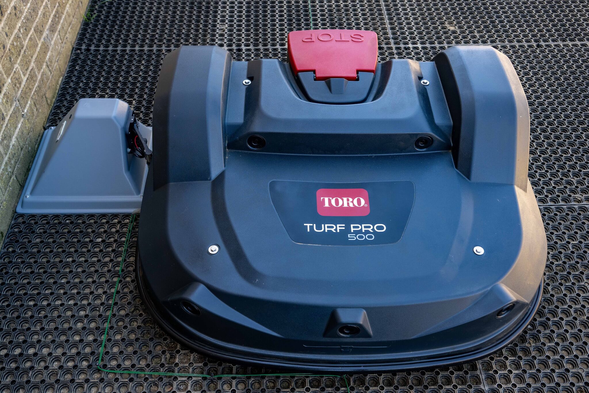 A Toro Turf Pro robot mower on charge.