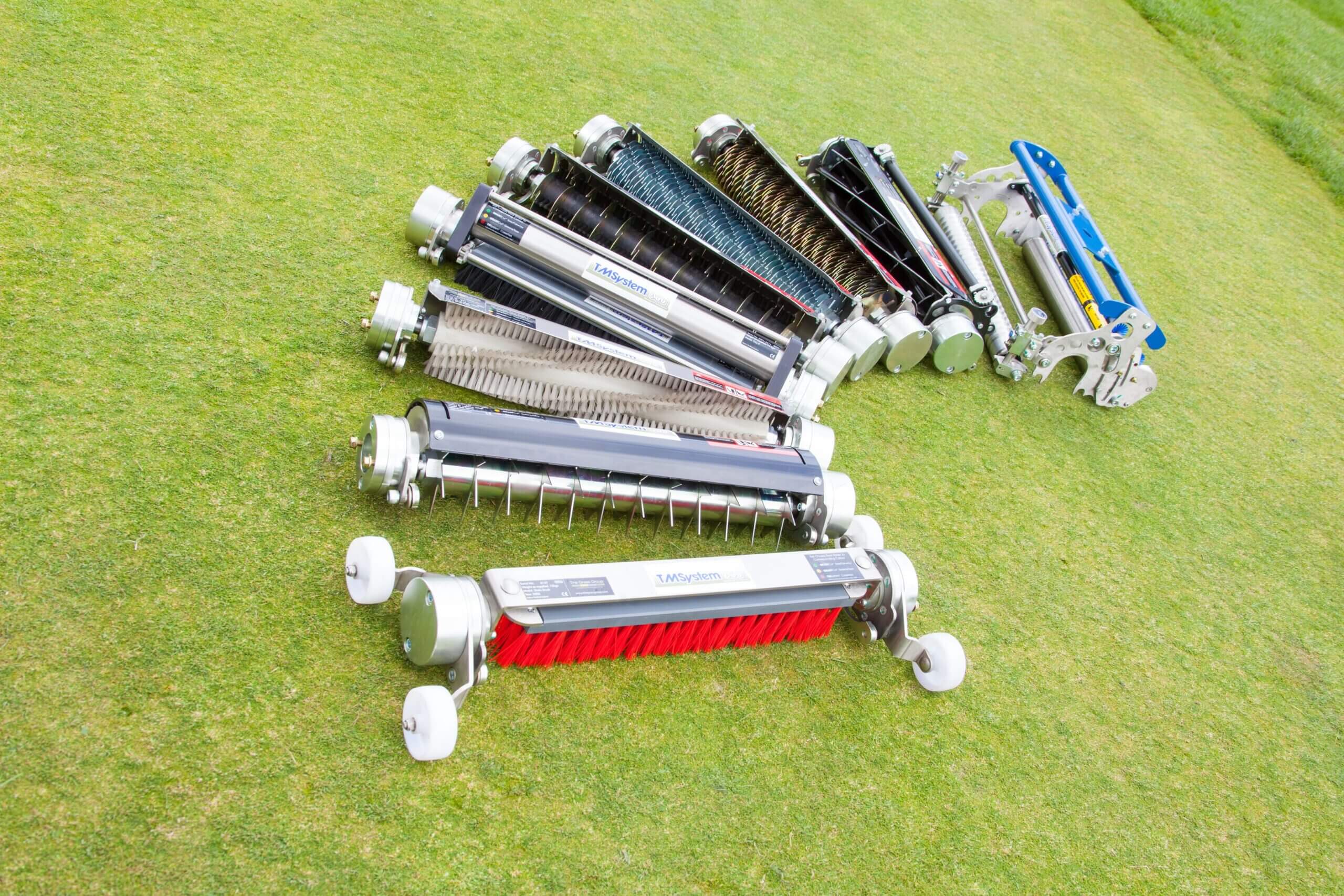 ATT TM System attachments lined up on turf.