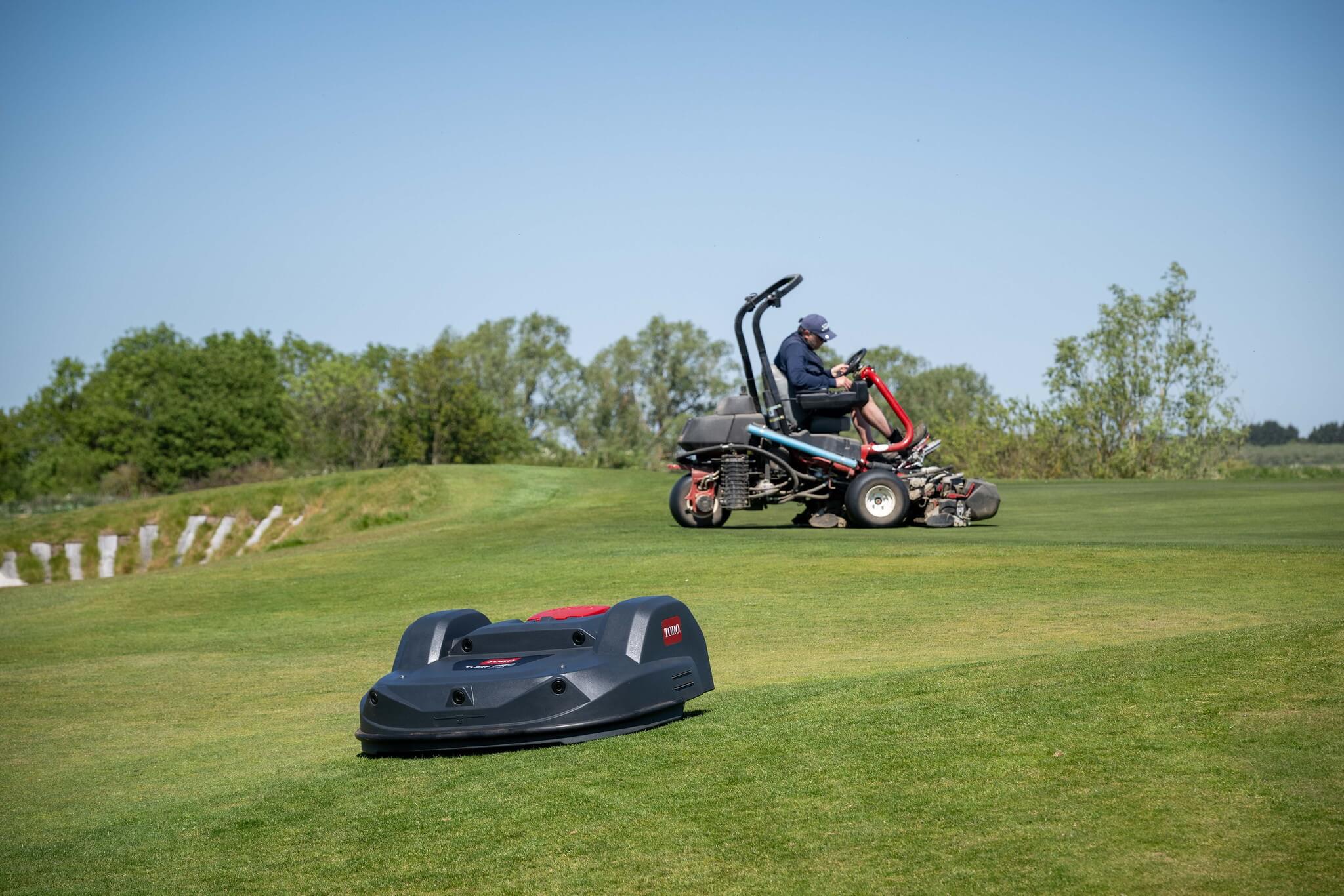A Toro Turf Pro 500 mower working in unison with a greenkeeper on a ride-on Toro mower.