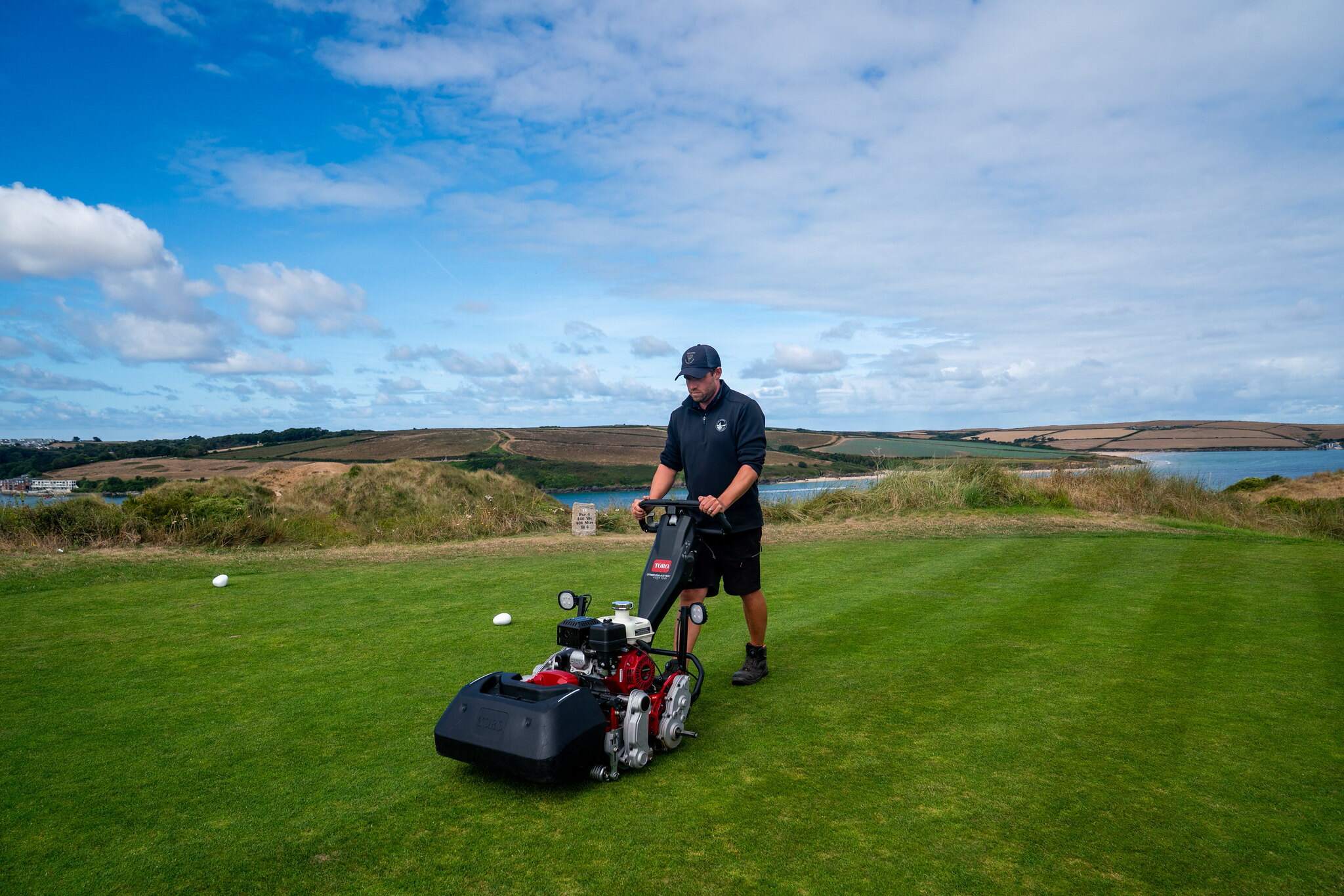 Greenkeeper using a Toro Greensmaster 1021 on the golf course