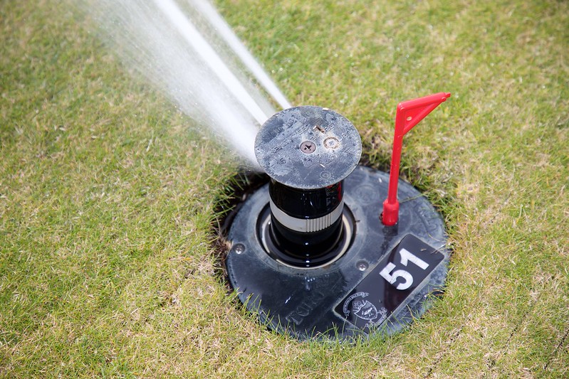 A close up of an operating sprinkler head at Royal Dornoch.