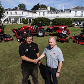 Manor of Groves Golf Club course manager Lee Brinkley, left, stands in front of the club’s second Toro fleet, shaking hands with Reesink’s Richard Freeman.