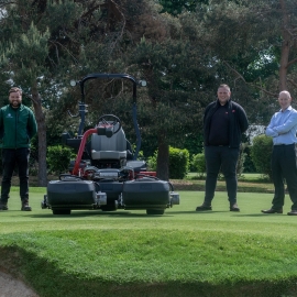 From left: course manager Ryan Bezzant, Reesink’s Tom Clark and Fulwell’s director of golf Peter Hall standing on a green next to the club’s brand new Greensmaster eTriFlex 3370.